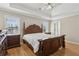 Spacious main bedroom featuring a tray ceiling, hardwood floors, and natural light at 2882 Manor Glen Ln, Suwanee, GA 30024