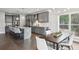 Stylish kitchen with gray cabinets, an island with seating, and a dining area at 3143 Stonegate Sw Dr, Atlanta, GA 30331