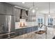 Modern kitchen featuring a large island, stainless steel appliances, gray cabinets, and granite countertops at 3143 Stonegate Sw Dr, Atlanta, GA 30331