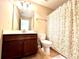 Bathroom with wood vanity, large mirror, and shower/tub combination at 4125 Madison Bridge Dr, Suwanee, GA 30024