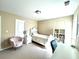 Cozy bedroom with natural light, a bed, desk, and decorative flower decor, creating a comfortable space at 4125 Madison Bridge Dr, Suwanee, GA 30024