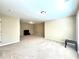 Spacious bonus room offers neutral carpet, multiple light sources, and a television at 4125 Madison Bridge Dr, Suwanee, GA 30024