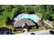 Aerial view of community pool with lounge chairs, sun deck, and a surrounding fence at 4125 Madison Bridge Dr, Suwanee, GA 30024