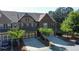 Charming townhome features a multi-car garage, brick exterior, and green front yard at 4125 Madison Bridge Dr, Suwanee, GA 30024