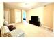 Neutral living room featuring carpeted floors, seating, and a television set against a beige wall at 4125 Madison Bridge Dr, Suwanee, GA 30024