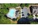 Aerial view of a kidney-shaped community pool, parking area, and landscaped surroundings at 4125 Madison Bridge Dr, Suwanee, GA 30024