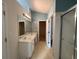 Bright bathroom featuring dual sinks and an open doorway at 50 Cold Springs Ct, Covington, GA 30016