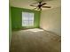 Bright bedroom with neutral walls, a ceiling fan, and a large window at 50 Cold Springs Ct, Covington, GA 30016