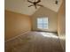 Spacious bedroom featuring a ceiling fan and a bright window with natural light at 50 Cold Springs Ct, Covington, GA 30016