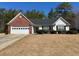 Charming single-story home with a two-car garage and meticulously manicured lawn at 50 Cold Springs Ct, Covington, GA 30016