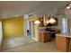 Open kitchen layout with island, wooden cabinets, and adjoining dining space with natural light at 50 Cold Springs Ct, Covington, GA 30016