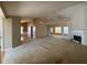 Open-concept living room featuring a cozy fireplace and abundant natural light at 50 Cold Springs Ct, Covington, GA 30016