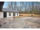 Exterior backyard featuring a home with a dark door and large concrete patio at 5151 Martins Crossing Rd, Stone Mountain, GA 30088