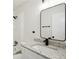 A bathroom featuring a vanity with stone countertops, a modern faucet, a framed mirror, and shower at 5151 Martins Crossing Rd, Stone Mountain, GA 30088