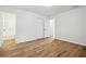 A bedroom featuring vinyl floors, neutral-toned walls, with doors that provide access to other areas of the house at 5151 Martins Crossing Rd, Stone Mountain, GA 30088