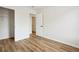 Bright bedroom featuring a closet and an open doorway with wood-look flooring and neutral walls at 5151 Martins Crossing Rd, Stone Mountain, GA 30088