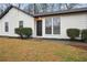 A charming home featuring a stone facade, a black front door, and manicured landscaping at 5151 Martins Crossing Rd, Stone Mountain, GA 30088