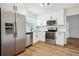 Modern kitchen with stainless steel appliances, white cabinetry, and granite countertops at 5151 Martins Crossing Rd, Stone Mountain, GA 30088