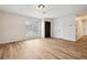 Spacious living room with natural light, featuring new flooring and fresh paint at 5151 Martins Crossing Rd, Stone Mountain, GA 30088