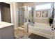 Luxurious bathroom featuring a glass enclosed shower and a soaking tub at 221 Begonia Way, Mcdonough, GA 30253