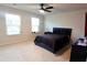 Modern bedroom with dark accents, ceiling fan, and large windows at 221 Begonia Way, Mcdonough, GA 30253