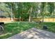 Large backyard with a concrete area, tree coverage, and a wooden fence at 3003 Maple Ln, Alpharetta, GA 30009