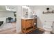 Modern bathroom with single vanity, black hardware, and an open doorway into another room at 3003 Maple Ln, Alpharetta, GA 30009