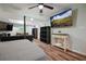 Bedroom features wood flooring, TV, shelving unit, and a table with drawers at 3003 Maple Ln, Alpharetta, GA 30009