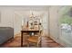 Charming dining area featuring wood floors, chandelier, and access to outdoor deck creating a seamless transition to the outdoors at 3003 Maple Ln, Alpharetta, GA 30009