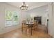 Sunlit dining room with tile floors, access to the backyard, a chandelier, and seamless flow to the Gathering room at 3003 Maple Ln, Alpharetta, GA 30009