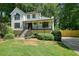 Inviting two-story home with covered porch, complimented by a well-maintained lawn and fencing at 3003 Maple Ln, Alpharetta, GA 30009