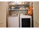 Well-organized laundry room with side-by-side washer and dryer, and shelves for storage at 3003 Maple Ln, Alpharetta, GA 30009