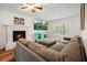 Inviting living area featuring a fireplace, media console, sectional sofa, and a TV at 3003 Maple Ln, Alpharetta, GA 30009