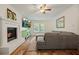 Cozy living room with a fireplace, TV, sectional sofa, and hardwood flooring at 3003 Maple Ln, Alpharetta, GA 30009