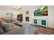 Stylish living room featuring a fireplace, TV, modern furniture, and hardwood floors at 3003 Maple Ln, Alpharetta, GA 30009