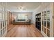 Spacious living room with French doors, a cozy couch, and modern shelving at 3003 Maple Ln, Alpharetta, GA 30009