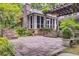 Stone patio with a pergola, exterior fireplace, and beautiful landscaping creates a backyard entertaining space at 366 Blackland Nw Rd, Atlanta, GA 30342