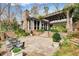 Inviting stone patio with a pergola, outdoor seating, and a fire pit for relaxing evenings at 366 Blackland Nw Rd, Atlanta, GA 30342