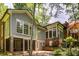 Exterior elevation of home, showing detailed brick and gray siding, with green trees in the surrounding property at 366 Blackland Nw Rd, Atlanta, GA 30342