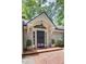 Elegant front door with decorative trim and brick walkway, complemented by potted plants and lush landscaping at 366 Blackland Nw Rd, Atlanta, GA 30342