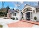 Stately home with a brick walkway leading to a covered entrance with manicured landscaping at 366 Blackland Nw Rd, Atlanta, GA 30342