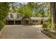 Charming home with a two-car garage, brick window feature, and a long driveway surrounded by lush greenery at 366 Blackland Nw Rd, Atlanta, GA 30342