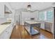 Stylish kitchen with white cabinetry, stainless appliances, large center island, and hardwood floors at 366 Blackland Nw Rd, Atlanta, GA 30342