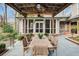 Outdoor dining area with seating for eight, a stone patio, and an overhead pergola with fans at 366 Blackland Nw Rd, Atlanta, GA 30342