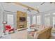 Bright sun room with a stone fireplace, comfortable seating, and plenty of natural light with ceiling fan at 366 Blackland Nw Rd, Atlanta, GA 30342