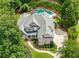 Stunning aerial view of a brick home with a pool, hot tub, and lush landscaping at 10275 Worthington Mnr, Suwanee, GA 30024