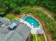 Luxury home with outdoor spa and pool with a basketball hoop, plus a covered patio and lounge area amid trees at 10275 Worthington Mnr, Suwanee, GA 30024