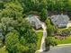 Aerial view of a beautiful luxury home surrounded by lush greenery with a private pool and meticulously landscaped grounds at 10275 Worthington Mnr, Suwanee, GA 30024