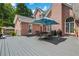 Backyard deck with seating and an umbrella for shade at 10275 Worthington Mnr, Suwanee, GA 30024