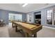 Basement featuring a shuffleboard table, bar seating, and a view into living area at 10275 Worthington Mnr, Suwanee, GA 30024